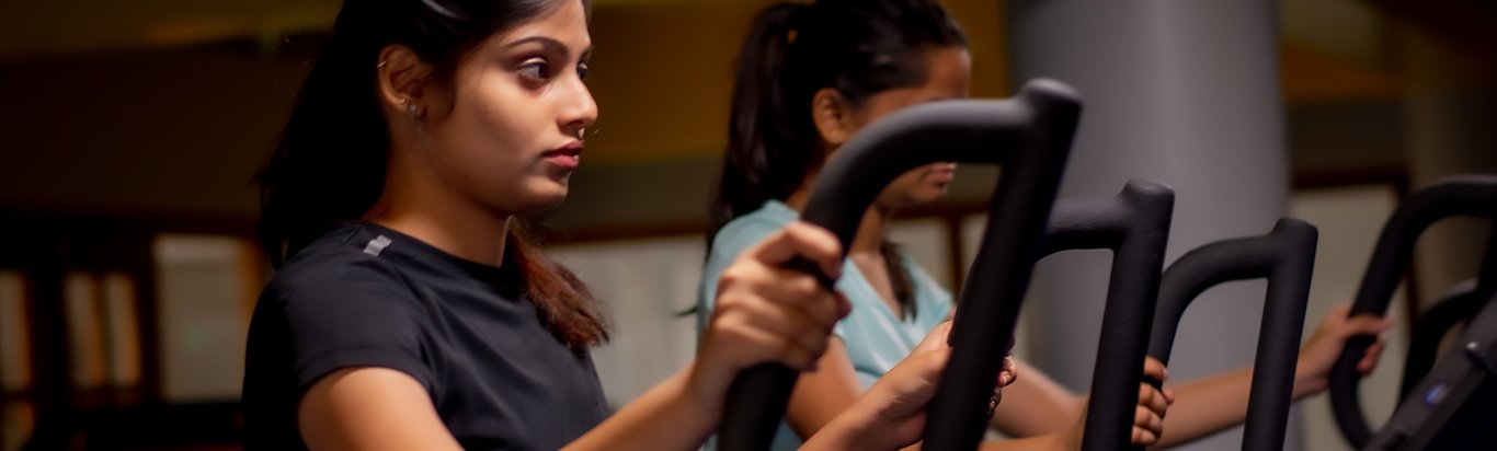Women using elliptical at hostel